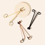 3 different colored candle wick trimmers