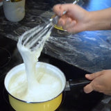 Stretchy, vegan mozzarella in a pot on a stovetop.